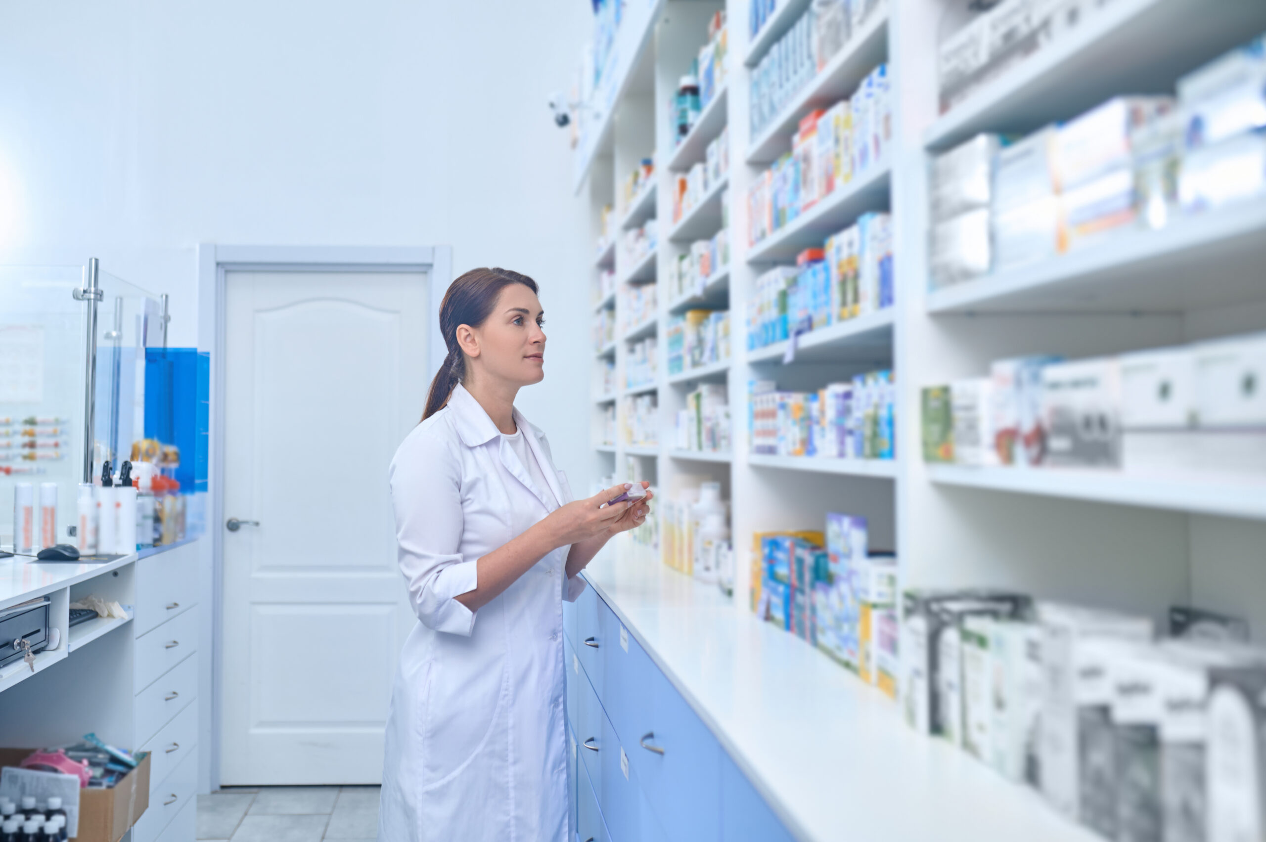 female pharmacist working drugstore scaled